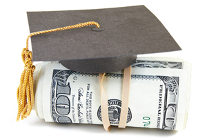 graduation cap on roll of bills